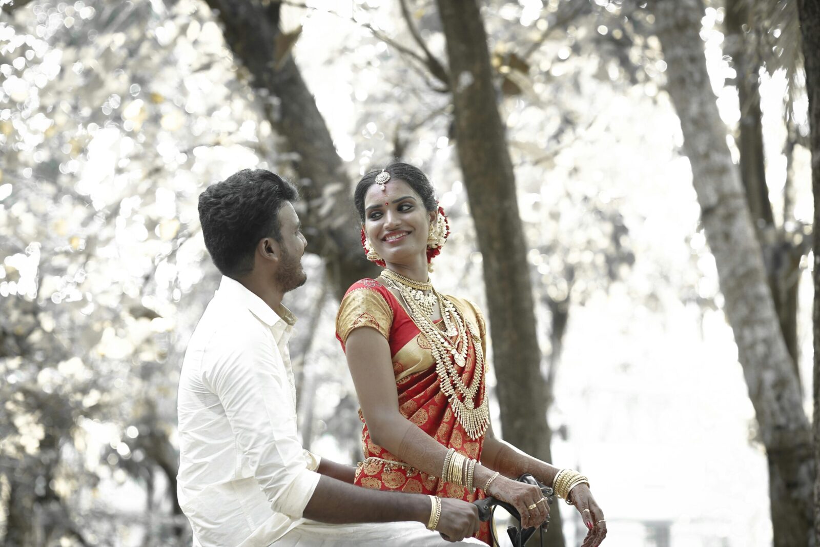 A joyful bride and groom enjoying their wedding day outdoors in KL, India.