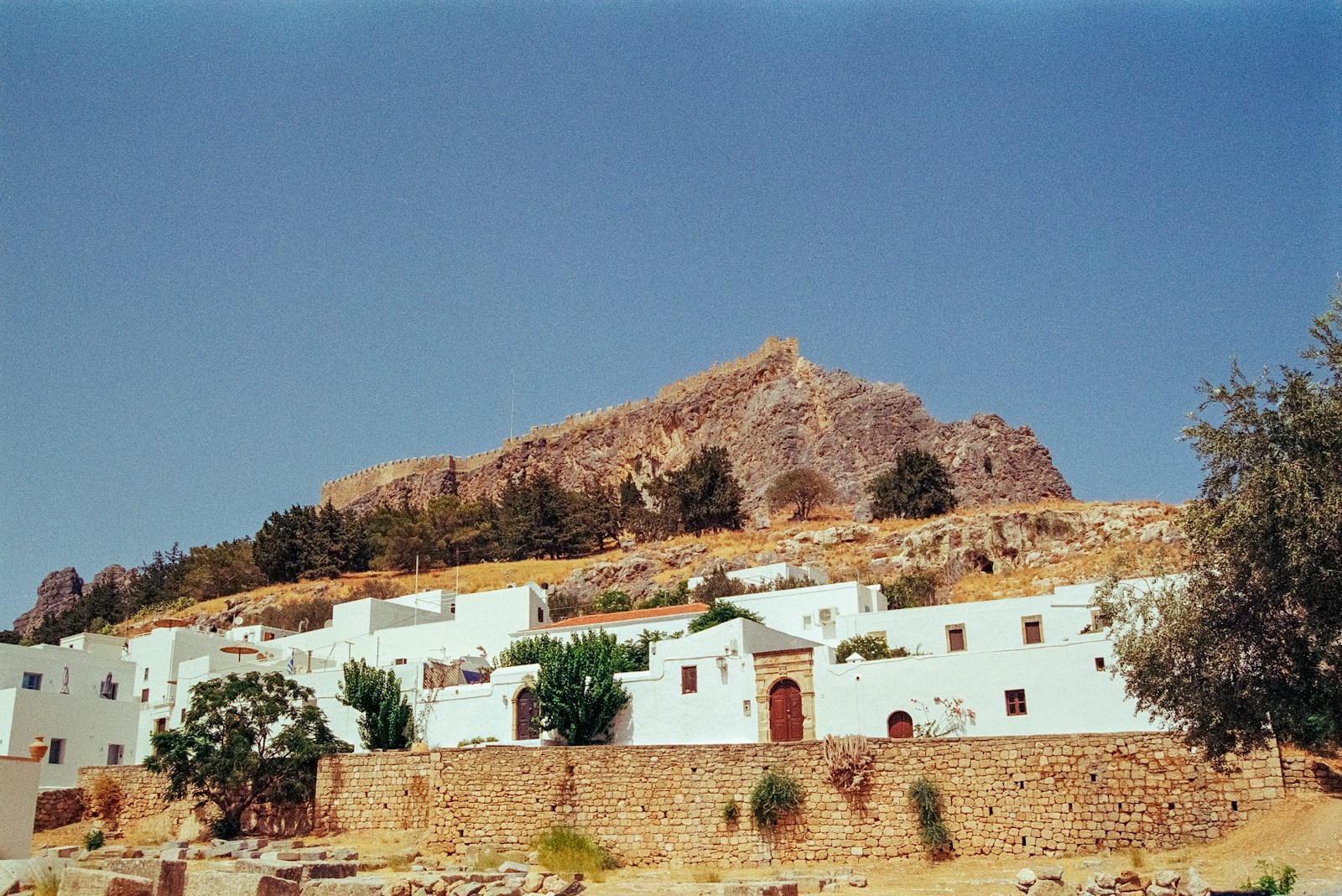 A white building with a mountain in the background
